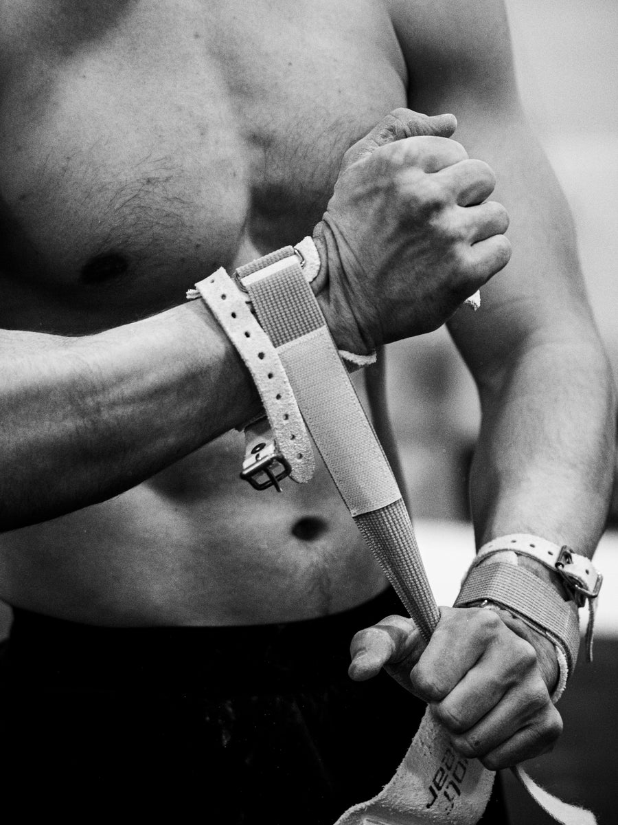 Gymnast chalking up wearing competition grips