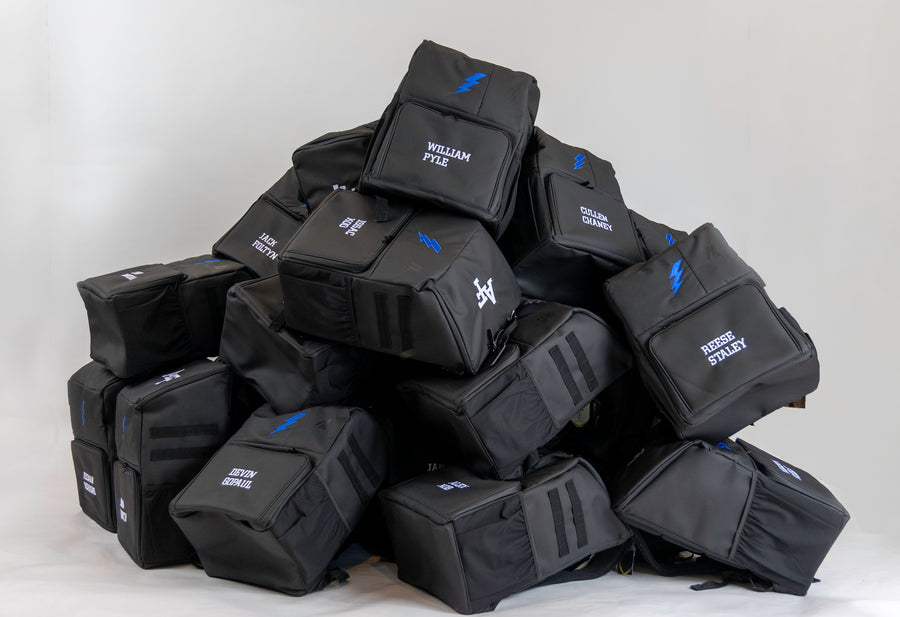 Pile of custom team gymnastics backpacks with athlete names