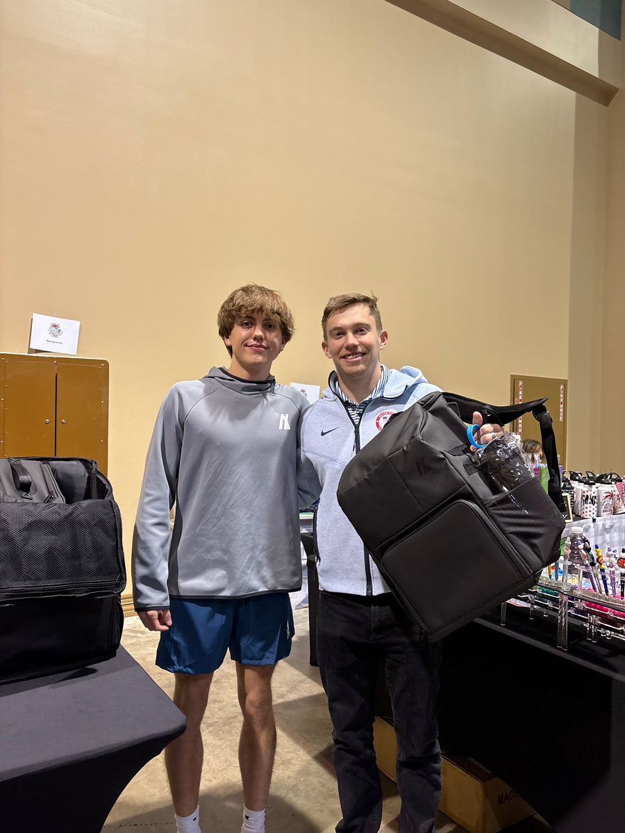 Athletes picking up their Locked In Athletics team backpacks at a meet