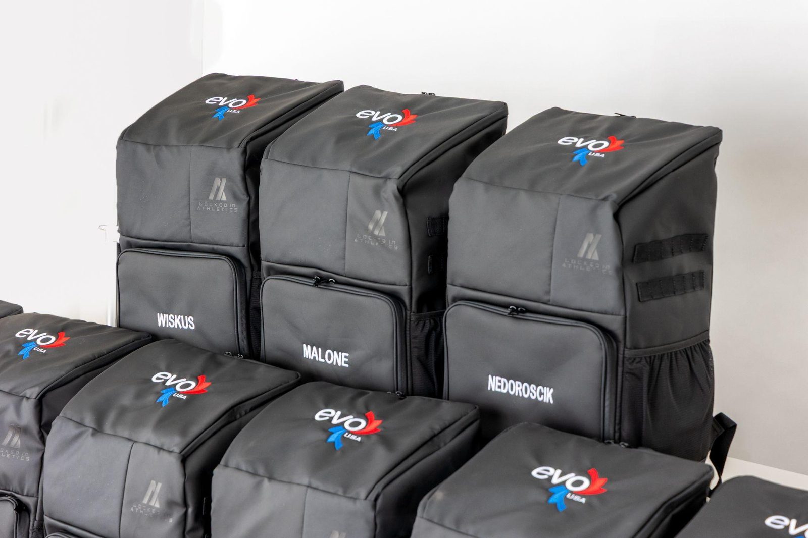 Custom team backpacks with heat pressed sublimated logos and athlete names