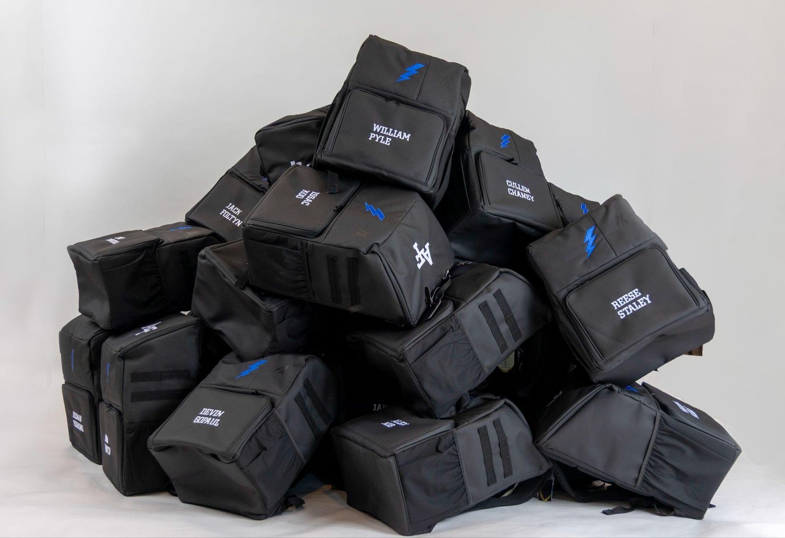 Stack of personalized Locked In Athletics team backpacks