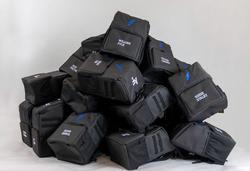 Stack of personalized Locked In Athletics team backpacks